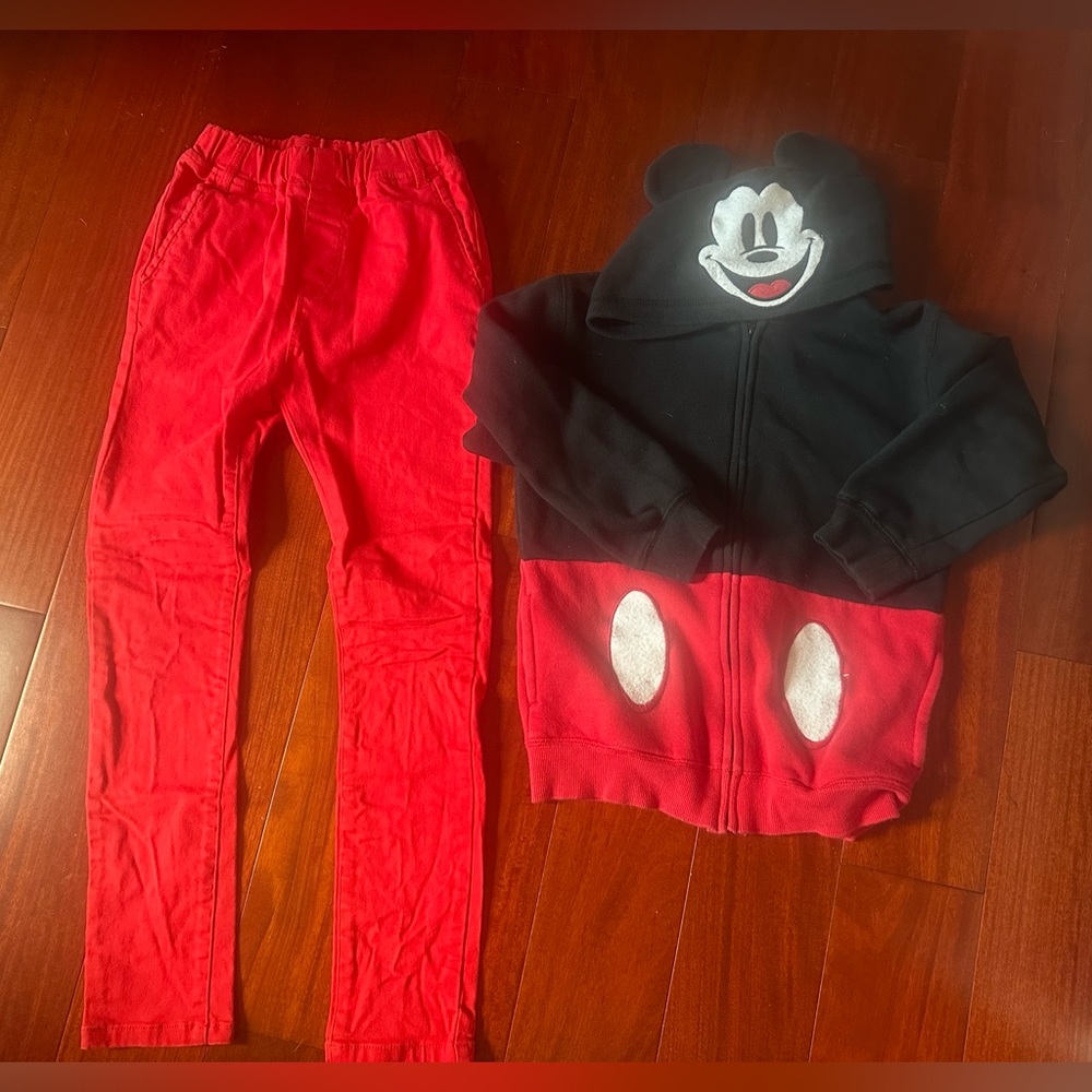 Disneyparks sweatshirt and red jeans.